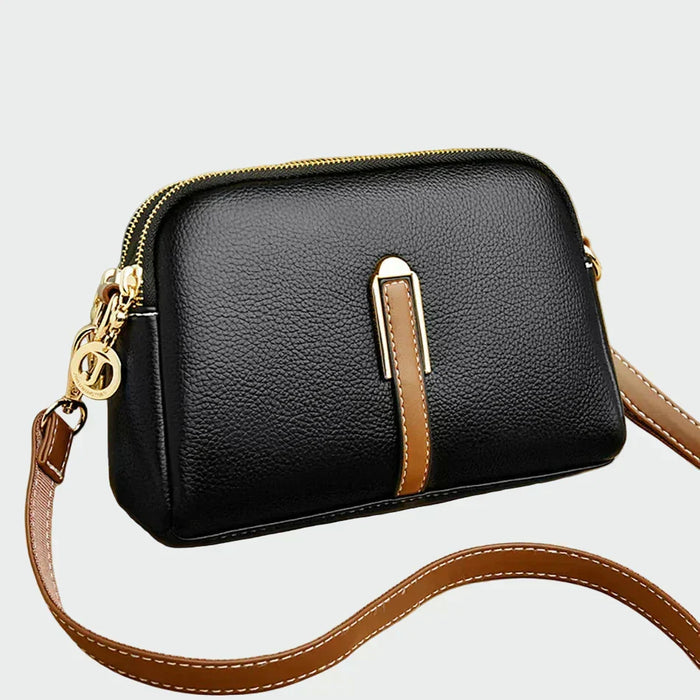 Sort crossbody-taske med brune detaljer